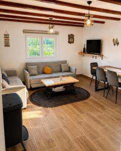 a living room with a couch and a table at Lipovo Mountain House in Kolašin