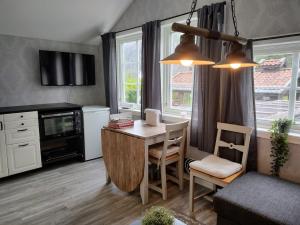 a living room with a desk and a table and chairs at Cozy Fjord Studio in Åna-Sira Near Brufjell and Jøssingfjord in Flekkefjord