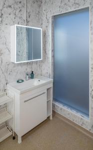 a bathroom with a white sink and a mirror at Lala Camp in Vama Buzăului
