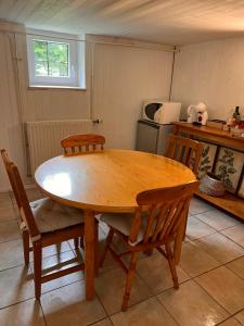 a wooden table and chairs in a kitchen at Roche for Toit in Rochefort
