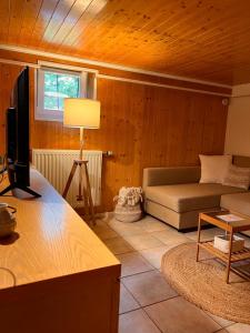 a living room with a couch and a television at Roche for Toit in Rochefort