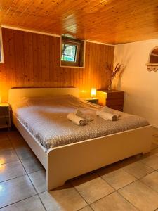 a bedroom with a bed with two towels on it at Roche for Toit in Rochefort