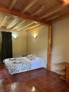 a bedroom with a bed in a room with wooden ceilings at Park hotel SVYAT in Skole +14 photos