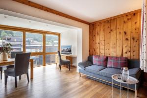 a living room with a couch and a table at Martinshof in Sankt Johann in Tirol