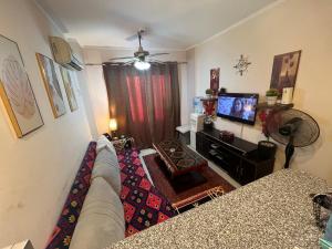 a living room with a couch and a flat screen tv at Chalet in Belagio Ain Sokhna in Ain Sokhna