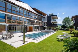 an exterior view of a house with a swimming pool at Martinshof in Sankt Johann in Tirol