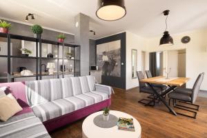 a living room with a couch and a table at Holiday Home Nevera in Kaštela