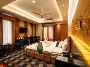 a hotel room with a bed and a bar at Sylhet Paradise Inn in Sylhet