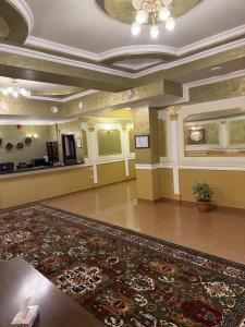 a large lobby with a large rug on the floor at The House Hotel Goris in Goris +45 photos