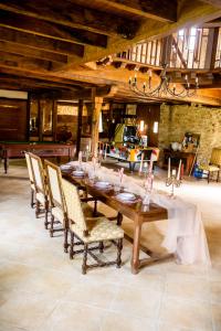 a dining room with a long wooden table and chairs at Chateau Eyparsac in Beyssac