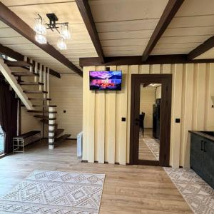a living room with a tv on a wall at Подих Свободи in Sloboda