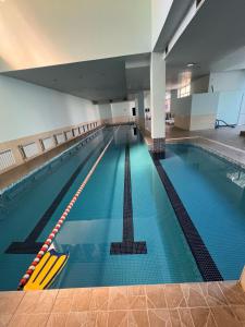 a large swimming pool in a large building at The House Hotel Goris in Goris