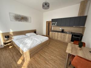 a bedroom with a bed and a table in it at Hotel Olympia Česká Lípa in Česká Lípa