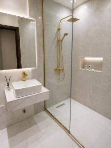 a bathroom with a sink and a glass shower at NO 5 Hotel in Lekki +15 photos