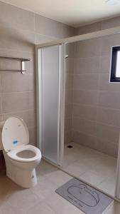 a bathroom with a toilet and a shower at Grass in the Wind B&B in Magong +16 photos