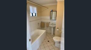 a bathroom with a tub and a toilet and a sink at Nest & Rest York in York
