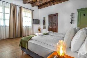 a large bedroom with two beds and a table at Wathay Vendégház in Csesznek