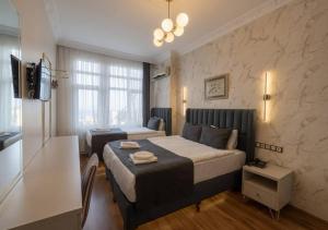 a bedroom with a bed and a television in a room at Hotel Tulip House in Istanbul