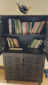 a book shelf filled with lots of books at Mzuri Homes in Kampala