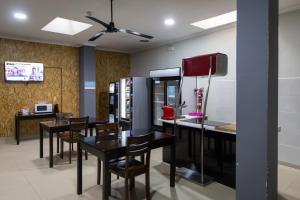 a dining room with tables and a refrigerator at Alda Centro Palencia in Palencia