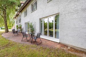 a patio with chairs and a table in front of a building at Apartments Lübeck in Lübeck