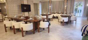 a large dining room with a table and chairs at Moorlandhouse & SPA in Migori