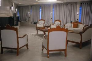 a living room with white chairs and a couch at Moorlandhouse & SPA in Migori