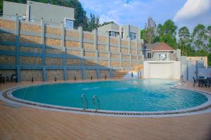 a swimming pool in front of a building at Moorlandhouse & SPA in Migori