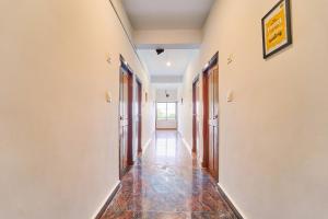 an empty hallway with a tile floor at Itsy Hotels R S Bhavan, 2 Km From MIT Gate in Manipal