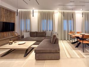 a living room with a couch and a table at Centaure Inn in Agios Dimitrios