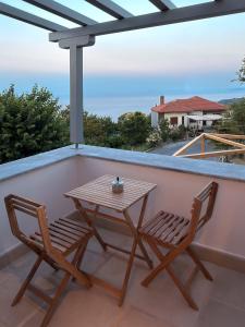 a table and two chairs on a balcony at Centaure Inn in Agios Dimitrios