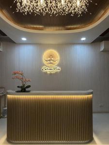 a lobby with a counter and a sign on a wall at Serene Rise Hotel Angeles City in Angeles
