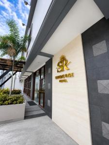 a building with a sign on the side of it at Serene Rise Hotel Angeles City in Angeles
