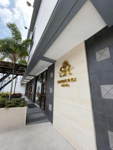 a building with a sign on the side of it at Serene Rise Hotel Angeles City in Angeles