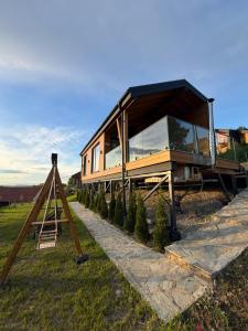 a house that is sitting on top of some trees at Royal Hill-Queen Chalet -Bran, Mountain View and Hot Tub in Sohodol