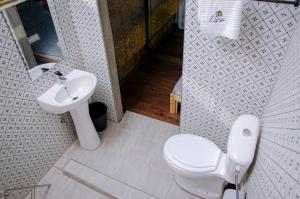 a bathroom with a toilet and a sink at Buvi Camp in Buvi