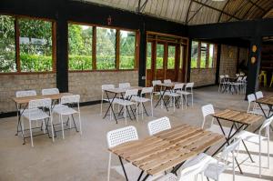 a room with tables and chairs and windows at Buvi Camp in Buvi +20 photos