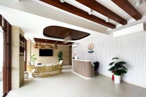 a hallway with a living room with a tv at Serene Rise Hotel Angeles City in Angeles