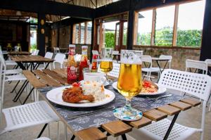 a table with a plate of food and a glass of beer at Buvi Camp in Buvi