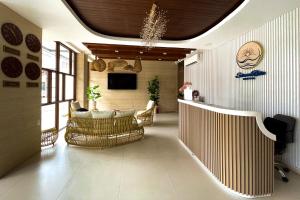 a lobby with chairs and a television in a building at Serene Rise Hotel Angeles City in Angeles +84 photos