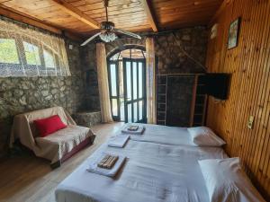 a bedroom with a bed and a chair in a room at Lana Seafront Apartments in Šušanj