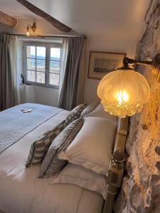a bedroom with a bed with a lamp on it at Hotel Le Saint Paul in Saint Paul de Vence