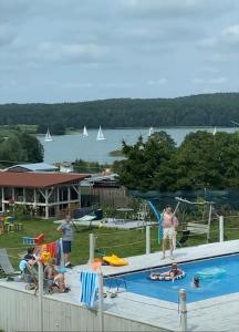 a group of people standing around a swimming pool at Rybical 42 in Rybical