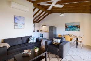 a living room with a couch and a table at Chandlers Smiths Beach Villas in Yallingup