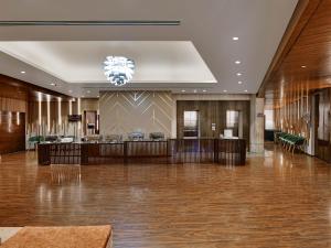 a large lobby with a reception desk and a chandelier at Hotel Suba International Sahar Road Mumbai in Mumbai
