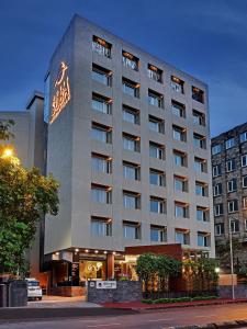 a hotel building with a sign on the side of it at Hotel Suba International Sahar Road Mumbai in Mumbai