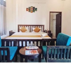 a bedroom with a bed and a table and chairs at Brahma Heritage Resort in Pushkar +4 photos