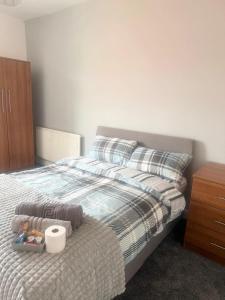 a bedroom with a bed with a wooden dresser and a drawer at Relaxing Private Bedroom Stay in Hull