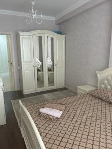 a bedroom with a bed and a chandelier at Light & Comfortе in Mekhrably