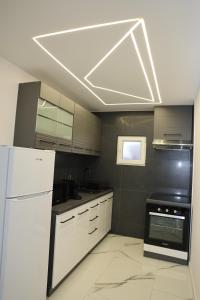 a kitchen with white appliances and a white ceiling at Elegant City Home-Free Parking in Timişoara
